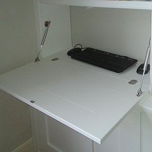 a drop down flap to form an inconspicuous desk area